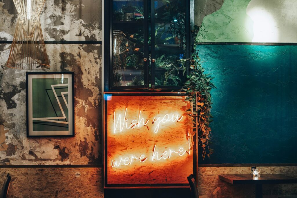 a neon sign in front of a green wall