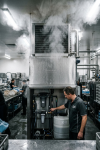 Industrial Hobart dishwasher with heat recovery system in commercial kitchen scullery