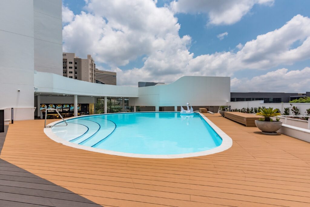 Rooftop swimming pool at Hotel Sky Sandton with city views and wooden deck