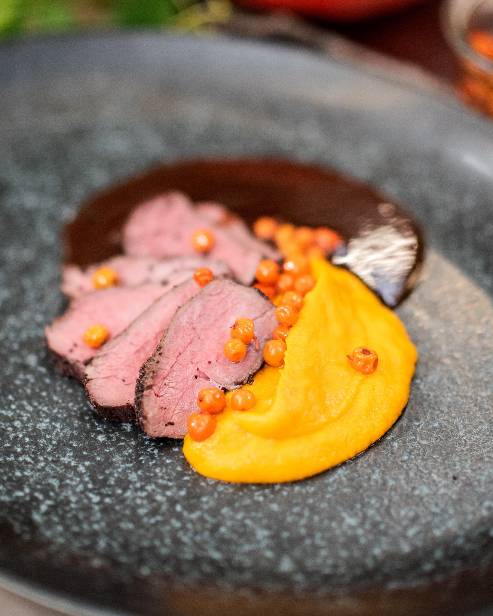 Silky-smooth pumpkin pur&eacute;e plated by a professional kitchen