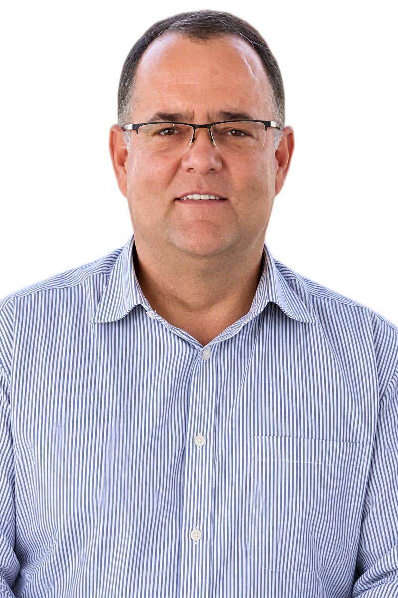 Portrait of Herman Janse van Rensburg in a blue and white striped shirt and glasses, against a white background